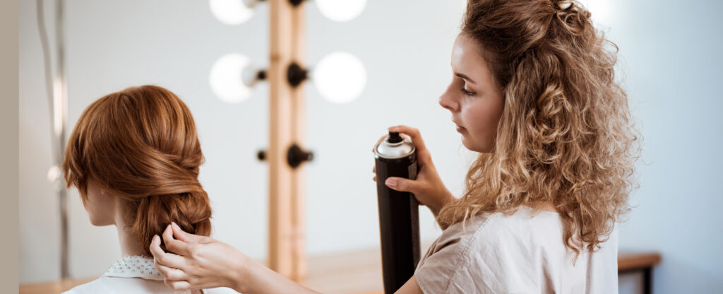 The Ultimate Guide to Flawless & Secure Hair Styling female hairdresser making hairstyle to redhead girl in beauty salon.