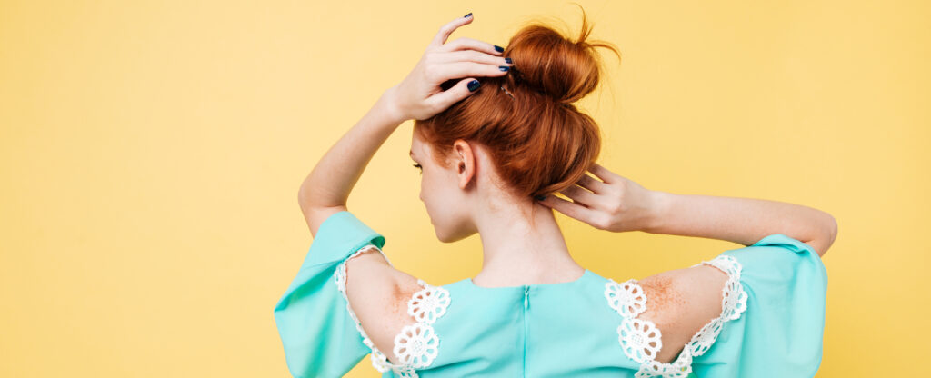 Cleanse & Hydrate Without Excess back view of enigmatic ginger woman in dress posing